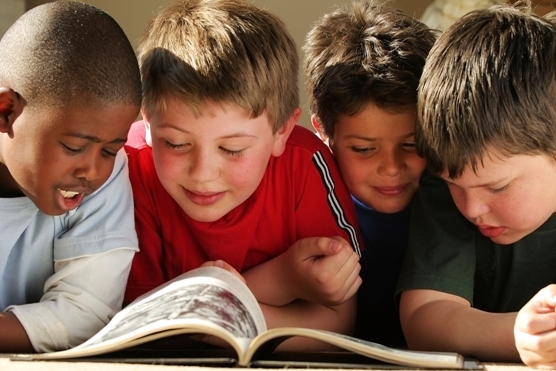 Four boys reading